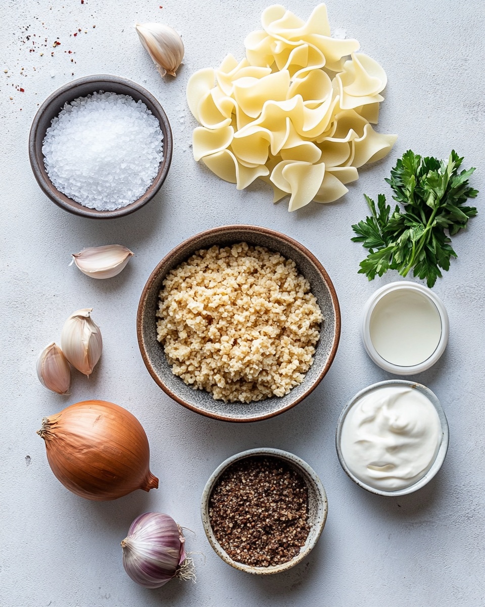 A close-up view of a white plate filled with creamy pasta layered evenly with flat, wide egg noodles that have a soft, light yellow color. The pasta is mixed thoroughly with small chunks of browned ground meat scattered throughout, coated in a shiny, smooth, beige sauce that looks rich and slightly thick with specks of green herbs giving little pops of color. The noodles have a slightly curled shape, showing their soft texture beneath the sauce. The plate sits on a white marbled surface. photo taken with an iphone --ar 4:5 --v 7