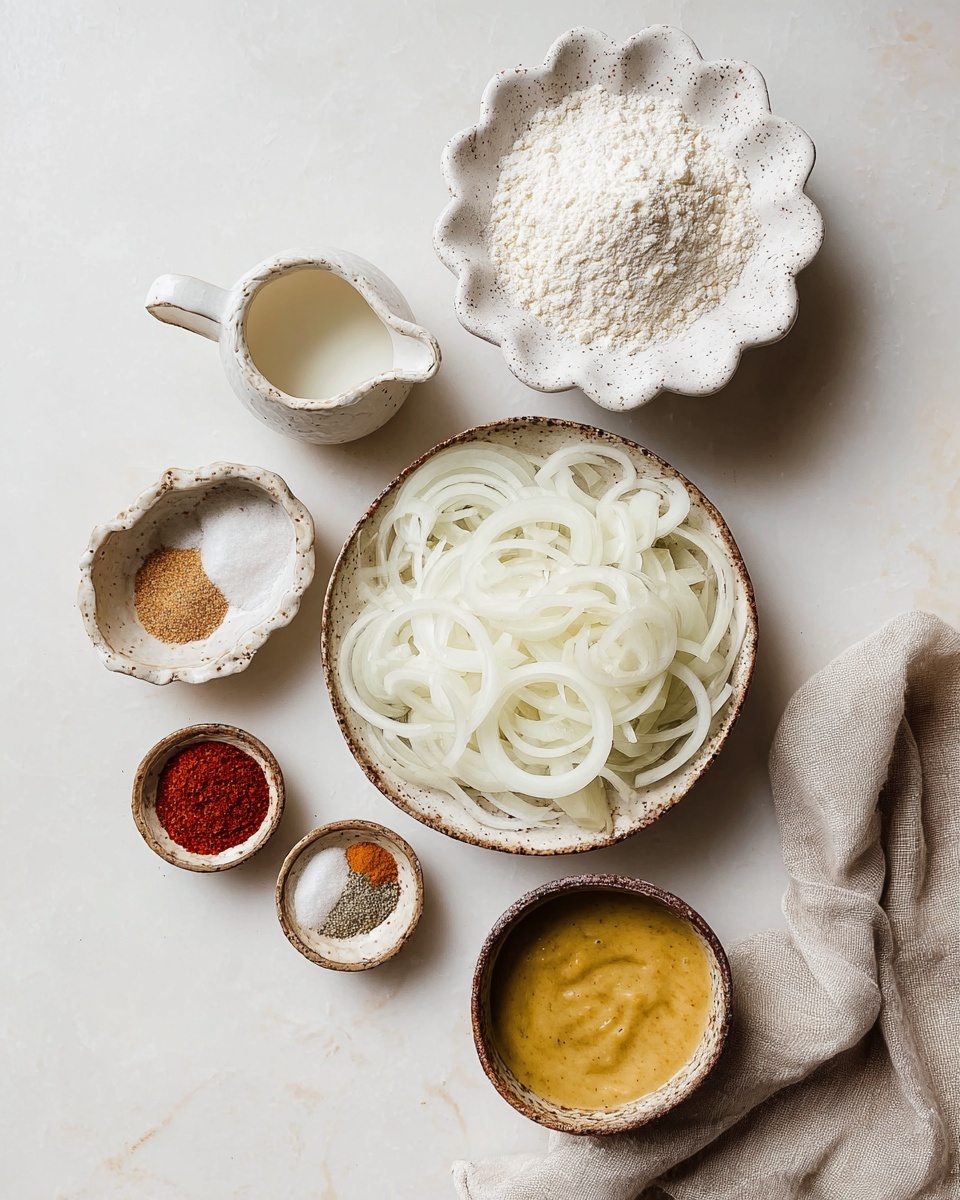 A deep bowl filled with a large pile of thin, golden-brown crispy fried onion rings, showing varied shades of light brown and darker edges, with coarse salt sprinkled on top. The onion rings have a crunchy texture, some twisted and curled, stacked others loosely scattered. Around the bowl, a small round dish with a light reddish dipping sauce with bits in it and another small bowl partly visible with coarse salt. All placed on a white marbled surface with a corner of a beige cloth visible below the bowl. Photo taken with an iphone --ar 4:5 --v 7