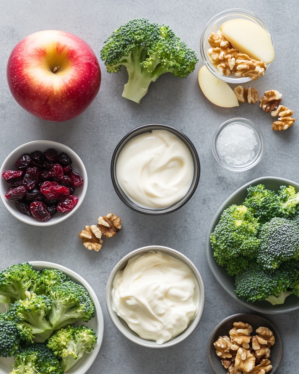A clear glass bowl holds layers of fresh ingredients evenly placed in sections: bright green broccoli florets fill the bottom left area, small apple cubes with red skin sit in the top left, deep red dried cranberries take the center top, light brown walnut pieces lie beside them, fresh chopped green herbs rest in the middle, and light purple chopped onions are in the bottom right section. In the second image, all ingredients are mixed together, showing a colorful combination of green broccoli, pale yellow apple cubes with red skin, dark red cranberries, light brown walnuts, green herbs, and purple onion bits. A metal spoon is inside the bowl, and the whole scene is on a white marbled surface. Photo taken with an iphone --ar 4:5 --v 7
