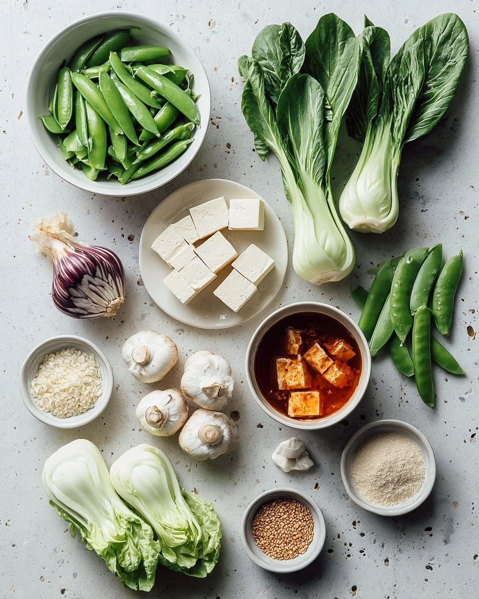The image shows an arranged collection of fresh ingredients on a white marbled surface. There is one black bowl on the top left with bright green snap peas, some with peas visible inside, and two small black bowls on the right holding light brown sesame seeds and slightly darker toasted sesame seeds. In the center is a cluster of nine small, pale dumplings with soft folds. Three baby bok choy heads with green leaves and white stems are placed near the top. Below, pieces of cut white tofu sit next to a bowl of red broth with tofu cubes inside. There are three white mushrooms and one round white root vegetable near the bottom left. Also included are a bulb of garlic, some light green leafy vegetables, and three small bowls containing grains or seeds. A small white bowl with a dark brown liquid is near the center. The whole scene is lit softly and neatly arranged. photo taken with an iphone --ar 4:5 --v 7