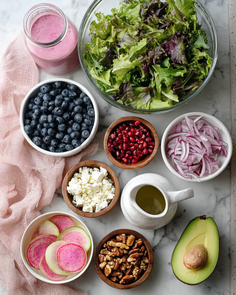A large white bowl filled with a colorful mixed salad placed on a white marbled surface. The salad has a green leafy base, topped with sliced light green avocado pieces fanned out evenly. Thin slices of pale purple-red onion and bright pink watermelon radish thin slices are scattered throughout. Deep blue blueberries and shiny red pomegranate seeds are spread across, adding rich color. Small white crumbles of cheese are sprinkled over the top. The salad is drizzled with a creamy pink dressing, adding a smooth texture that contrasts with the crunch of the nuts mixed in. A bottle with pink dressing and a bowl of blueberries are visible in the background. Photo taken with an iphone --ar 4:5 --v 7