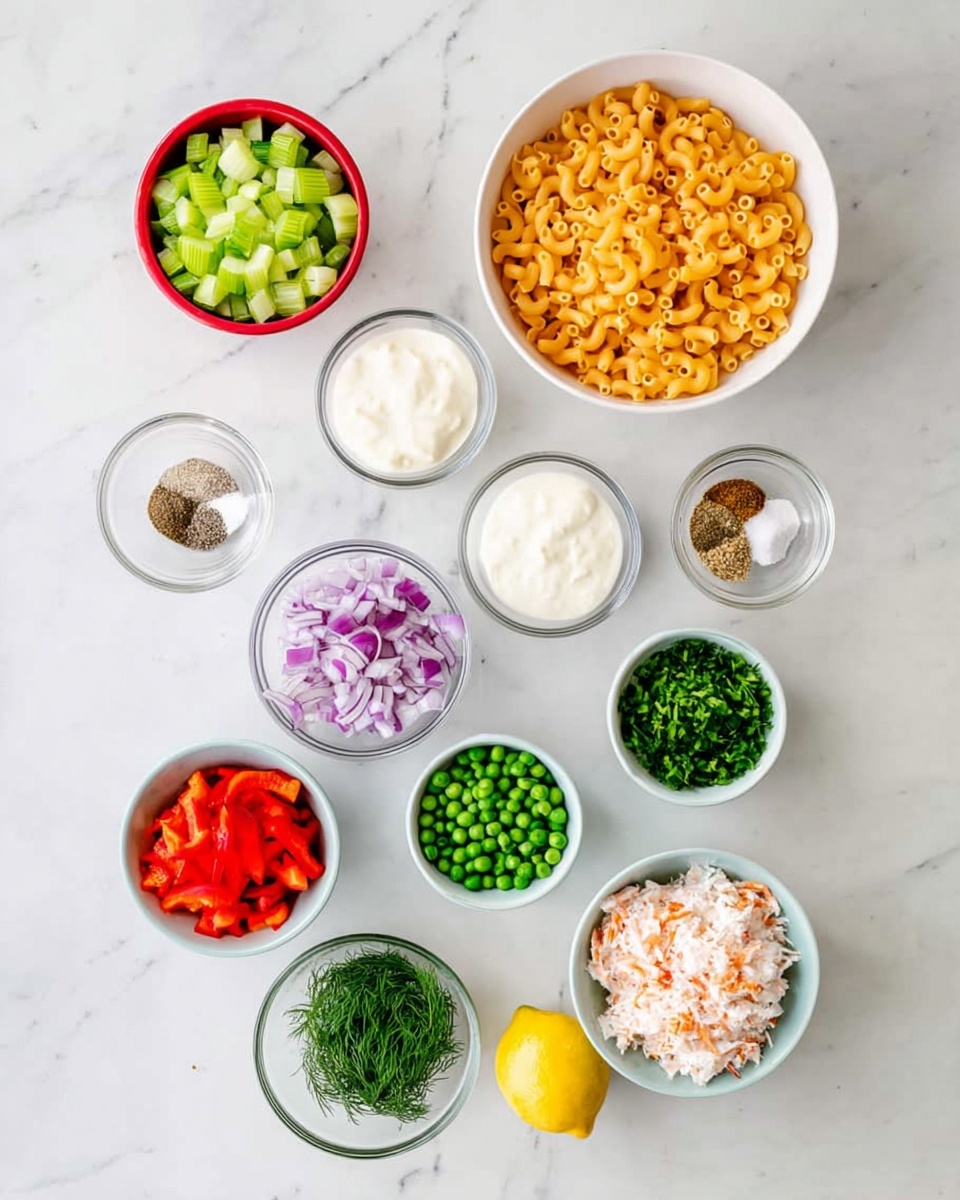 The image shows ten bowls and one lemon arranged on a white marbled surface. At the top right, a large white bowl is filled with orange macaroni pasta. To its left, a small red bowl holds chopped green celery. Below the pasta, a medium white bowl contains thick white mayo. To the right of the mayo, a small white bowl has chopped purple onion. Below the mayo, a small white bowl is filled with bright green peas. To the right, another small white bowl contains chopped green herbs. On the left, a small glass bowl has mixed spices: salt, black pepper, and paprika. Next to it, a small glass bowl holds fresh dill. At the bottom left, a small light blue bowl has chopped red bell pepper. To the right, a large white bowl contains chopped imitation crab meat, and a whole lemon sits just below it. All bowls show fresh ingredients with clear textures and colors photo taken with an iphone --ar 4:5 --v 7